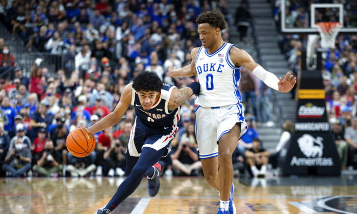 Gonzaga guard Julian Strawther (left) brings the ball up next to Duke forward Wendell Moore Jr. (0) during the first half of an NCAA college basketball game in Las Vegas, on Nov. 26, 2021. (Ellen Schmidt/AP Photo)