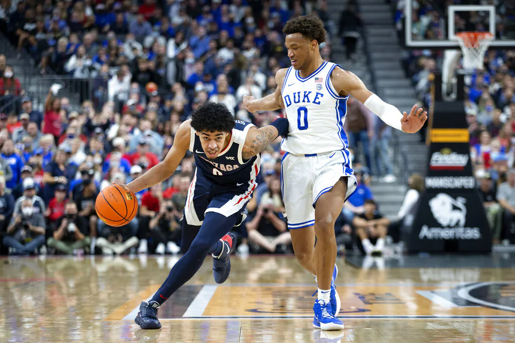 Gonzaga guard Julian Strawther (left) brings the ball up next to Duke forward Wendell Moore Jr. (0) during the first half of an NCAA college basketball game in Las Vegas, on Nov. 26, 2021. (Ellen Schmidt/AP Photo)