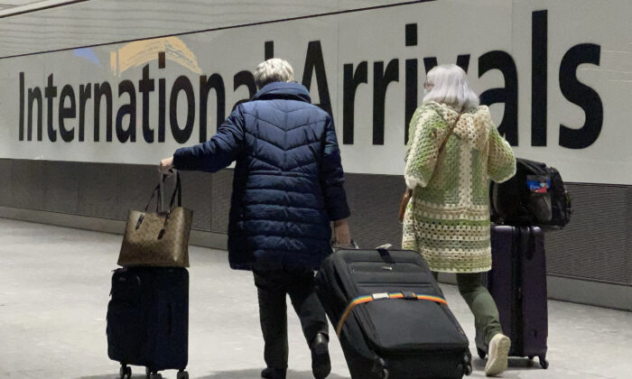 International passengers walk through the arrivals area at Terminal 5 at Heathrow Airport in London on Nov. 26, 2021. (Leon Neal/Getty Images)
