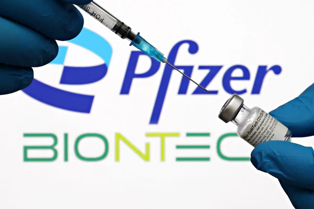 A medical syringe and vials of the Pfizer U.S. pharmaceutical corporation and BioNTech German biotechnology company logos are seen in New York City on Oct. 3, 2021. (Cindy Ord/Getty Images for Pfizer/BioNTech)