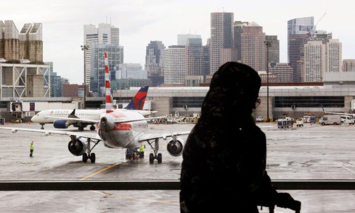 Delta Airlines and an American Airlines planes taxi away from their gate ahead of the Thanksgiving holiday at Logan International Airport in Boston, Mass., on Nov. 22, 2021. (Brian Snyder/Reuters)