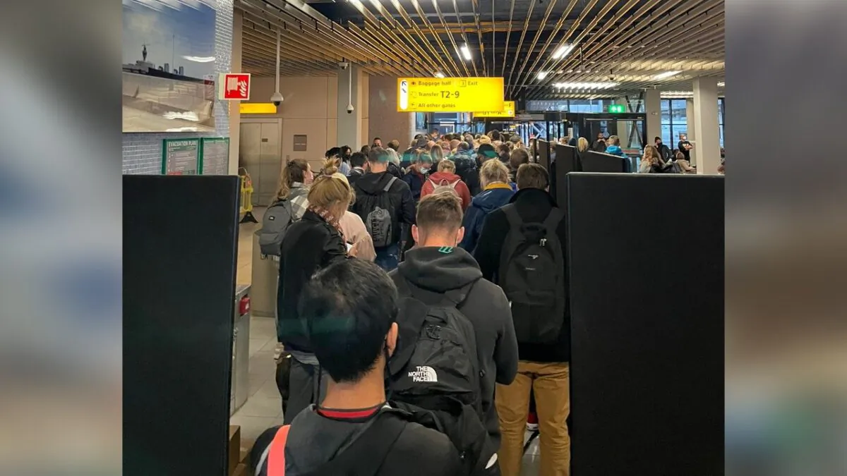 Passengers traveling from South Africa line up to be tested for COVID-19 after being held on the tarmac at Schiphol Airport, Netherlands, on Nov. 25, 2021. (Social media via Reuters)