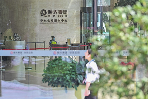 A police officer is seen at the lobby of the Evergrande Center building in Shanghai on September 24, 2021. (Hector Retamal/AFP via Getty Images)