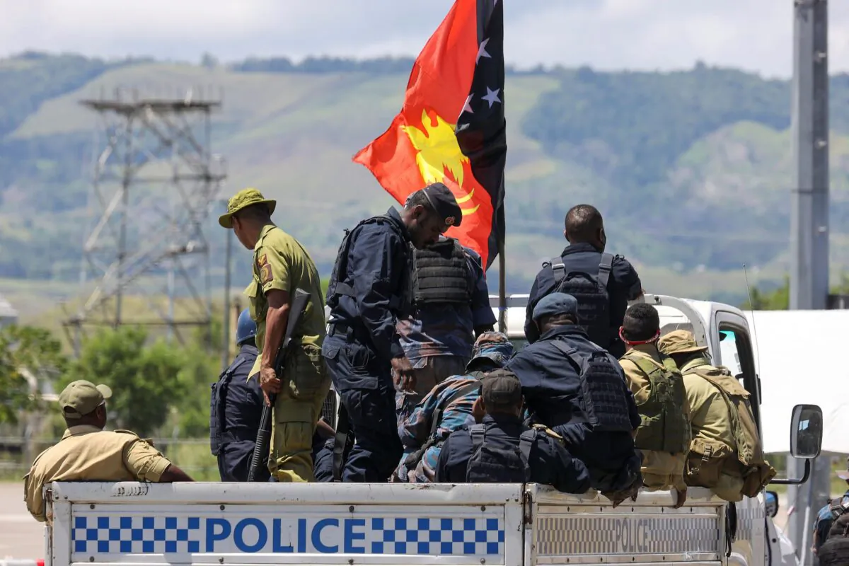 Papua New Guinea police arrive at the airport in Honiara, Solomon Islands, on Nov. 27, 2021. (Gary Ramage via AP)