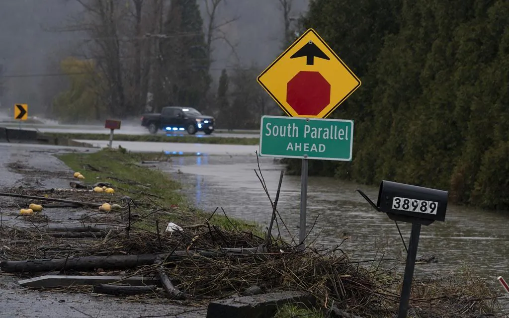 Debris is pictured along a flooded road in Abbotsford, B.C., November 25, 2021. (The Canadian Press/Jonathan Hayward)