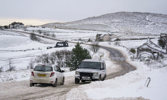 Vehicles travel tentatively on the snow-covered A53 close to Buxton in Derbyshire, amid freezing conditions in the aftermath of Storm Arwen, England, on Nov. 28, 2021.  (Jacob King/PA via AP)