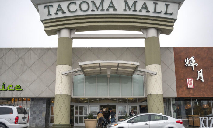 People walk into the north entrance of the Tacoma Mall in Tacoma, Wash., on Nov. 27, 2021. (Pete Caster/The News Tribune via AP)