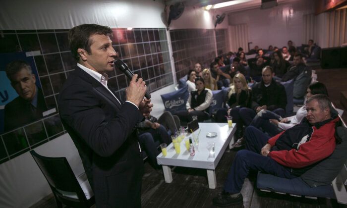 Yoel Razvozov, a lawmaker of the centrist Yesh Atid party, addresses Russian-speaking Israelis as he campaigns in a pub in Bat Yam, south of Tel Aviv, Israel, on Feb. 8, 2015. (Baz Ratner/Reuters)