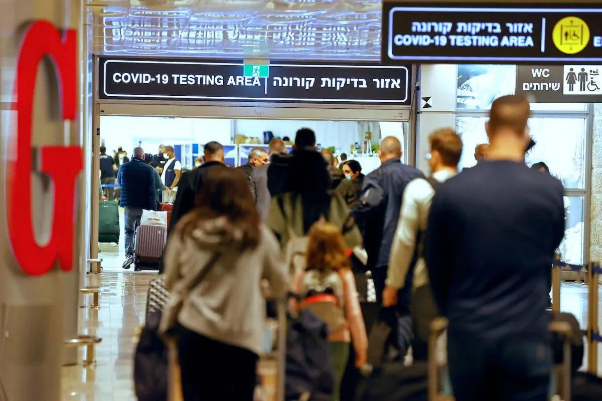 Passengers walk with their luggage upon their arrival at Ben Gurion Airport near Lod, Israel, on Nov. 1, 2021. (Jack Guez/AFP via Getty Images)