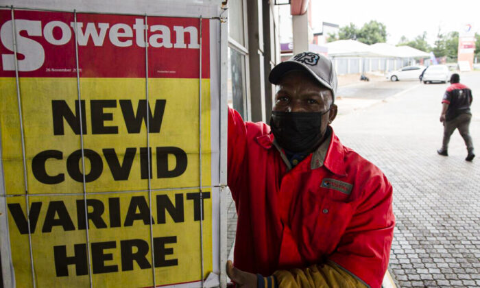 A petrol attendant stands next to a newspaper headline in Pretoria, South Africa, on Nov. 27, 2021. As the world grapples with the emergence of the new variant of COVID-19, scientists in South Africa—where Omicron was first identified—are scrambling to combat its spread across the country. (AP Photo/Denis Farrell)