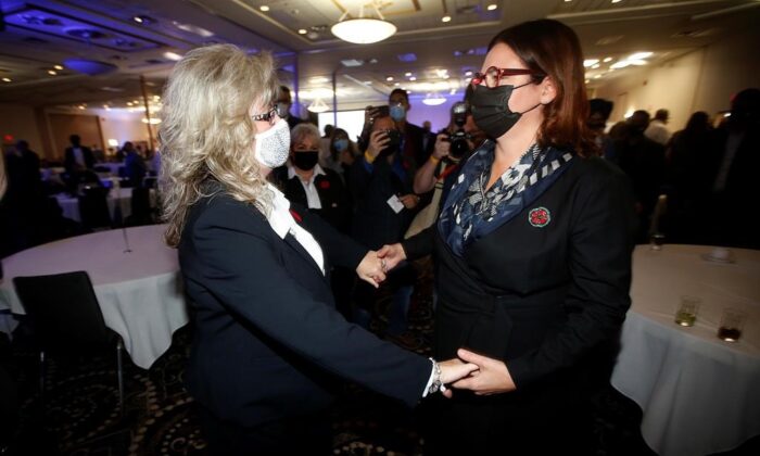 Manitoba Conservative Leader and the province's new premier, Heather Stefanson, right, greets opponent Shelly Glover at a victory party after defeating her in a leadership race in Winnipeg, October 30, 2021. (The Canadian Press/John Woods)