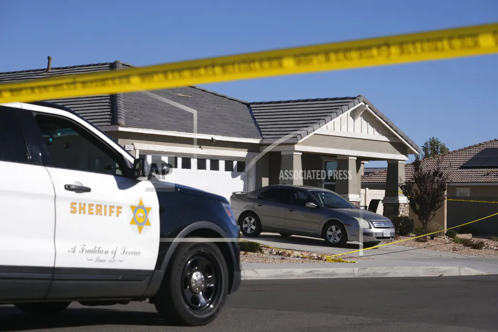 Los Angeles County Sheriff deputies guard a home in the city of Lancaster in the high desert Antelope Valley north of Los Angeles on Nov. 29, 2021. (Ringo H.W. Chiu/AP Photo)
