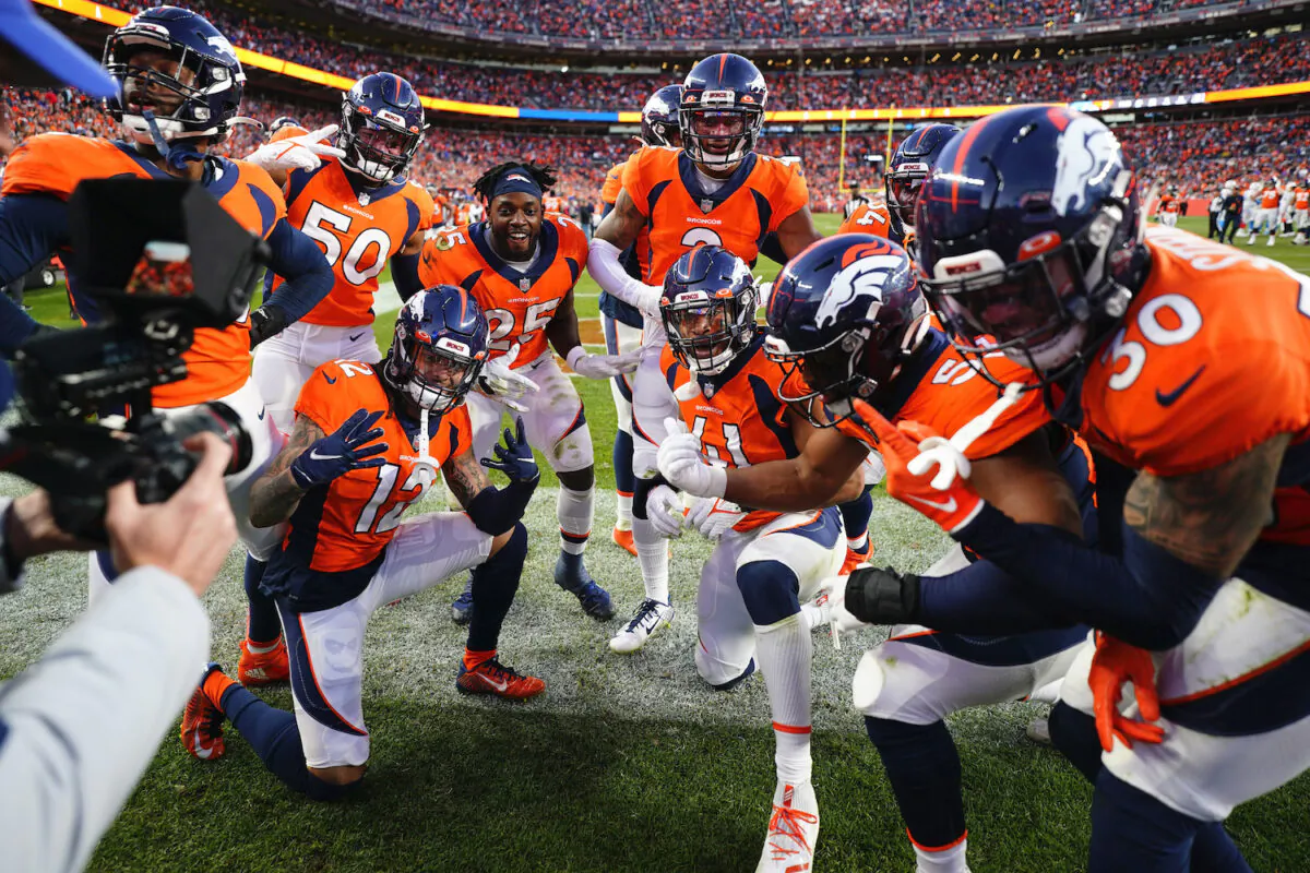 The Denver Broncos defense celebrates cornerback Pat Surtain II's, center, interception during the second half of an NFL football game against the Los Angeles Chargers in Denver on Nov. 28, 2021. (AP Photo/Jack Dempsey)