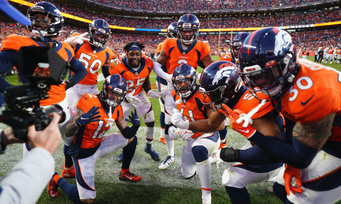 The Denver Broncos defense celebrates cornerback Pat Surtain II's, center, interception during the second half of an NFL football game against the Los Angeles Chargers in Denver on Nov. 28, 2021. (AP Photo/Jack Dempsey)