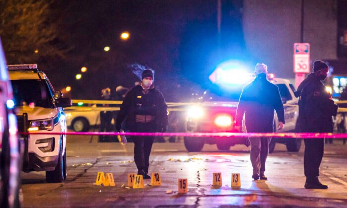 Chicago and Evanston police investigate a crime scene after a gunman went on a shooting spree before being killed by police during a shootout in Evanston, Ill., on Jan. 9, 2021. (Ashlee Rezin Garcia/Chicago Sun-Times via AP)