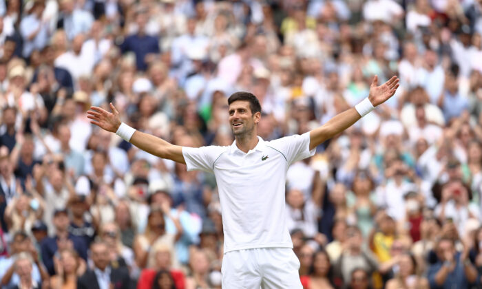 Novak Djokovic celebrates winning his men's Singles Final match against Matteo Berrettini of Italy on Day Thirteen of The Championships-Wimbledon 2021 at All England Lawn Tennis and Croquet Club in London on July 11, 2021. (Julian Finney/Getty Images)