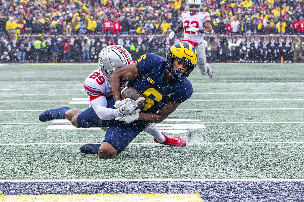 Ohio State cornerback Denzel Burke (29) tackles Michigan wide receiver Cornelius Johnson (6) before the end zone in the second quarter of an NCAA college football game in Ann Arbor, Mich., on Nov. 27, 2021. (Tony Ding/AP Photo)