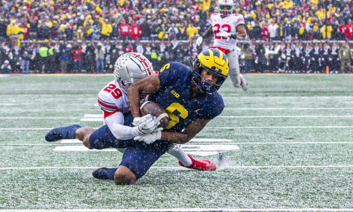 Ohio State cornerback Denzel Burke (29) tackles Michigan wide receiver Cornelius Johnson (6) before the end zone in the second quarter of an NCAA college football game in Ann Arbor, Mich., on Nov. 27, 2021. (Tony Ding/AP Photo)