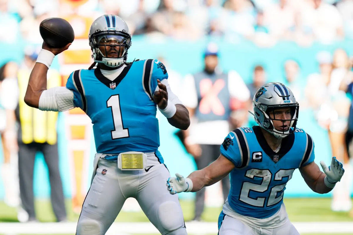Carolina Panthers quarterback Cam Newton (1) aims a pass as running back Christian McCaffrey (22) defends, during the first half of an NFL football game against the Miami Dolphins in Miami Gardens, Fla., on Sun. Nov. 28, 2021, (Wilfredo Lee/AP Photo)
