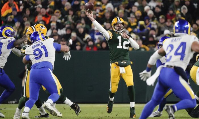 Green Bay Packers' Aaron Rodgers thorws a pass during the first half of an NFL football game against the Los Angeles Rams in Green Bay, Wis., on Nov. 28, 2021. (AP Photo/Morry Gash)