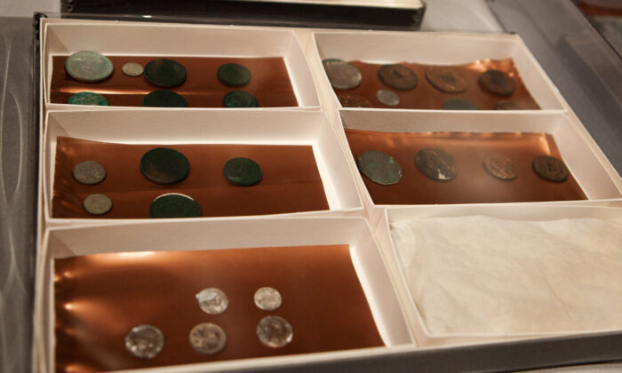 Silver and copper coins dating from 1652 to 1855, are displayed at the Museum of Fine Arts in Boston, on Jan. 6, 2015. (Kayana Szymczak/Getty Images)