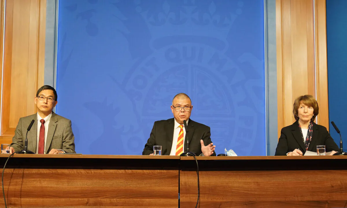 (L-R) Professor Wei Shen Lim, chair of JCVI's COVID-19 subcommittee; Professor Jonathan Van Tam, deputy chief medical officer for England; and Dr. June Raine, chief executive of the Medicines and Healthcare products Regulatory Agency, attend a media briefing at Downing Street Briefing Room in London on Nov. 29, 2021. (Stefan Rousseau/WPA Pool/Getty Images)