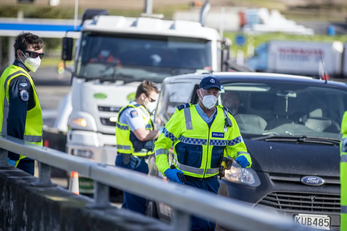 Police inspect vehicles at a road block on the outskirts of Auckland, New Zealand, on Sept. 30, 2021. (Michael Craig/NZ Herald via AP)