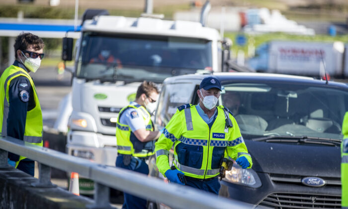 Police inspect vehicles at a road block on the outskirts of Auckland, New Zealand, on Sept. 30, 2021. (Michael Craig/NZ Herald via AP)