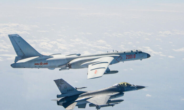 A Chinese PLA Air Force H-6 bomber flies near a Taiwan F-16 in this Feb. 10, 2020 handout photo provided by Taiwan Ministry of National Defense. In a statement, the ministry said Chinese J-11 fighters and H-6 bombers flew into the Bashi Channel to the south of Taiwan, then out into the Pacific before heading back to base via the Miyako Strait. (Taiwan Ministry of National Defense/Handout via Reuters)