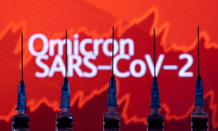 Syringes with needles are seen in front of a displayed stock graph and words "Omicron SARS-CoV-2" in this illustration taken, on Nov. 27, 2021. (Dado Ruvic/Illustration/Reuters)