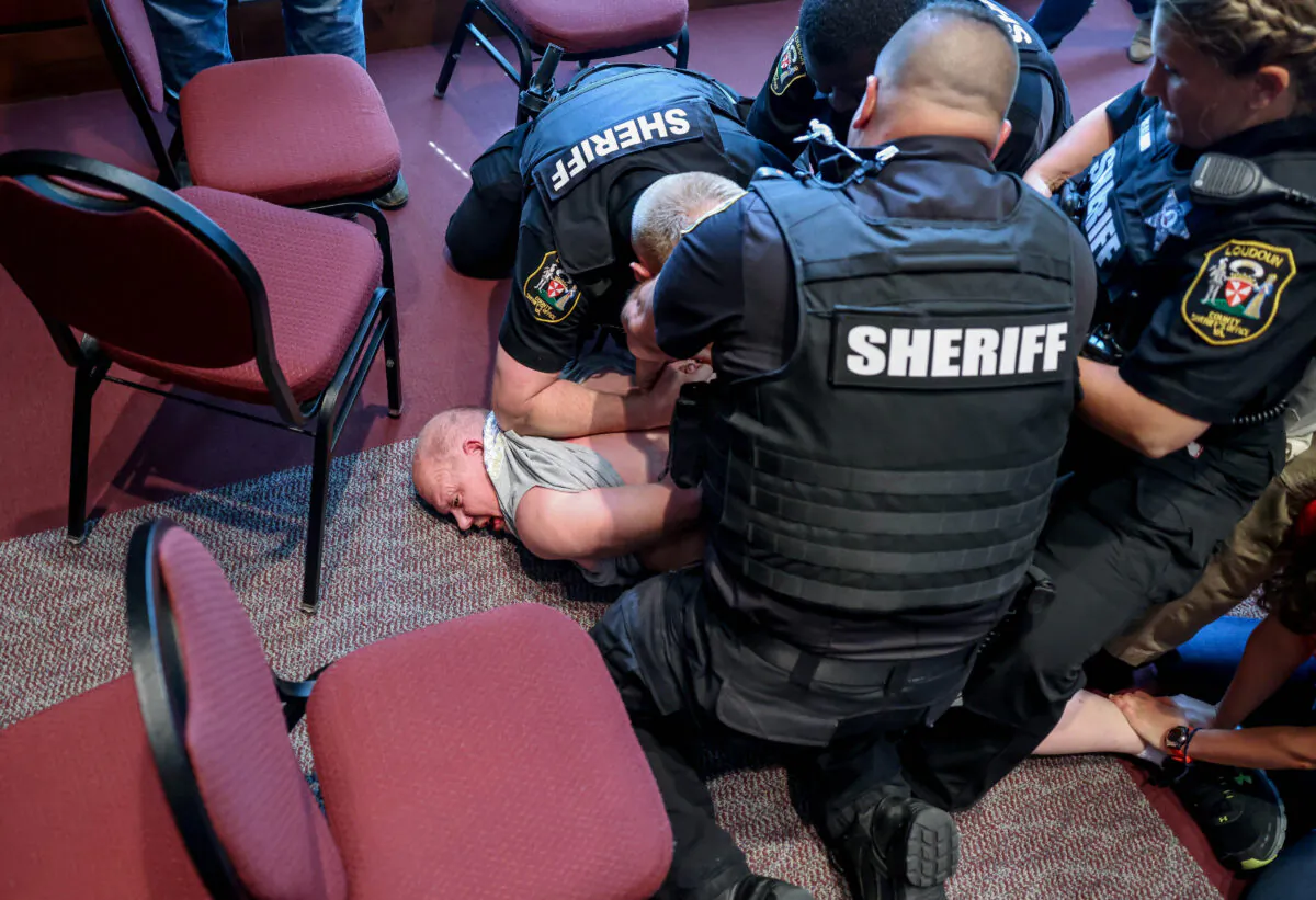 Scott Smith is arrested for disorderly conduct and obstruction of justice in Ashburn, Va., on June 22, 2021. (Evelyn Hockstein/Reuters)