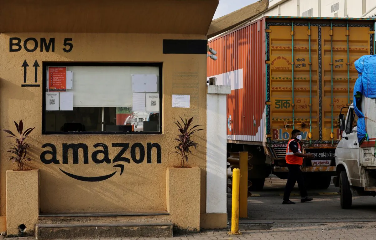 A man inspects trucks before they enter an Amazon storage facility on the outskirts of Mumbai, India, Oct. 1, 2021.  (Francis Mascarenhas/Reuters, File Photo)
