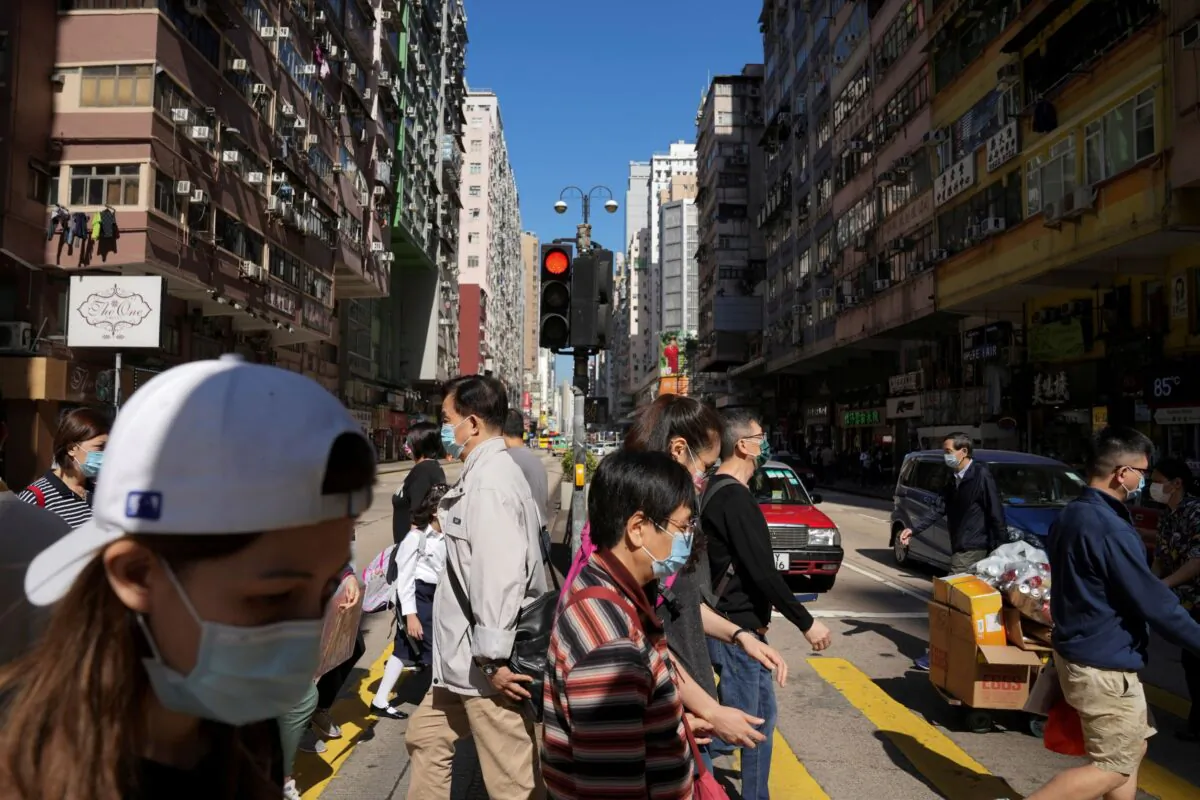 People crossing a street in Hong Kong, on Nov. 29, 2021. (Lam Yik/Reuters)