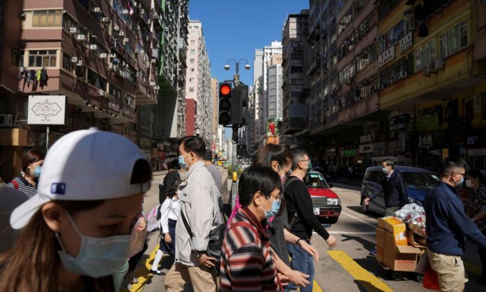 People crossing a street in Hong Kong, on Nov. 29, 2021. (Lam Yik/Reuters)