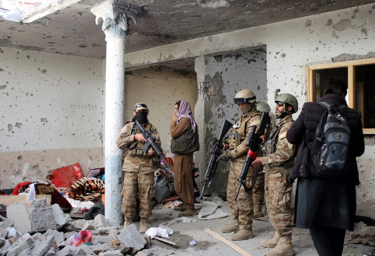 Taliban fighters inspect a house after an 8-hour gunbattle erupted between Taliban and ISIS terrorist group fighters, when Taliban forces raided a suspected hideout of ISIS extremists on the outskirts of Jalalabad, east of Kabul, Afghanistan, on Nov. 30, 2021. (Shir Shah Hamdard/AP Photo)