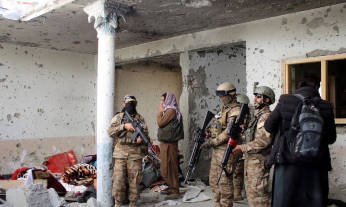 Taliban fighters inspect a house after an 8-hour gunbattle erupted between Taliban and ISIS terrorist group fighters, when Taliban forces raided a suspected hideout of ISIS extremists on the outskirts of Jalalabad, east of Kabul, Afghanistan, on Nov. 30, 2021. (Shir Shah Hamdard/AP Photo)