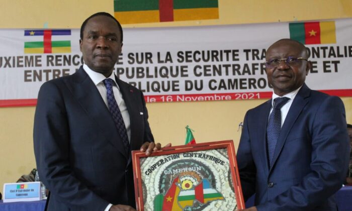 The defense minister of Cameroon, Joseph Beti Assomo (left), exchanges souvenir gifts with his Central African Republic counterpart,  Rameaux-Claude Bireau, after their trans-border security meeting. (Nalova Akua/The Epoch Times)