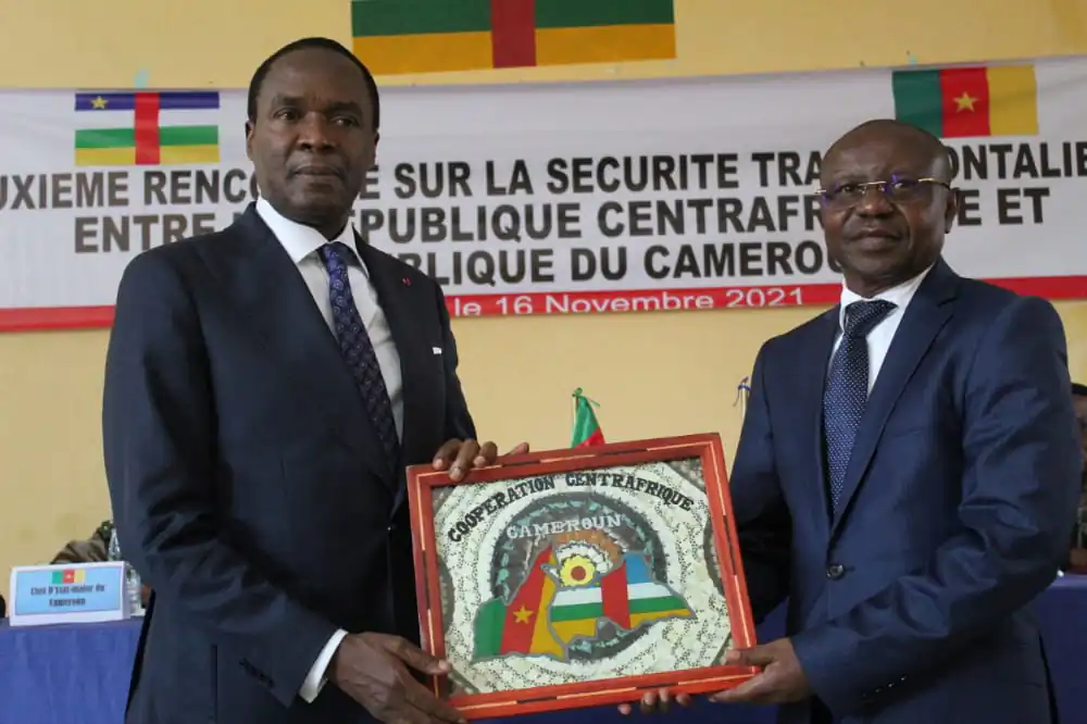 The defense minister of Cameroon, Joseph Beti Assomo (left), exchanges souvenir gifts with his Central African Republic counterpart, Rameaux-Claude Bireau, after their trans-border security meeting. (Nalova Akua/The Epoch Times)
