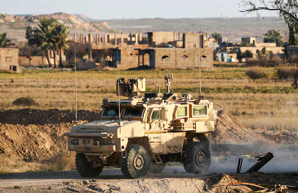 A US military vehicle drives through the Syrian village of Baghuz in the countryside of the eastern Deir Ezzor Province on Jan. 26, 2019. (Delil Souleiman/AFP/Getty Images)