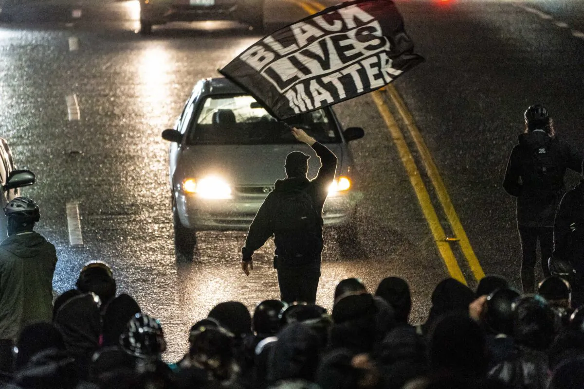 A protester waves a Black Lives Matter flag during protests in Seattle on Nov. 3, 2020. (David Ryder/Getty Images)