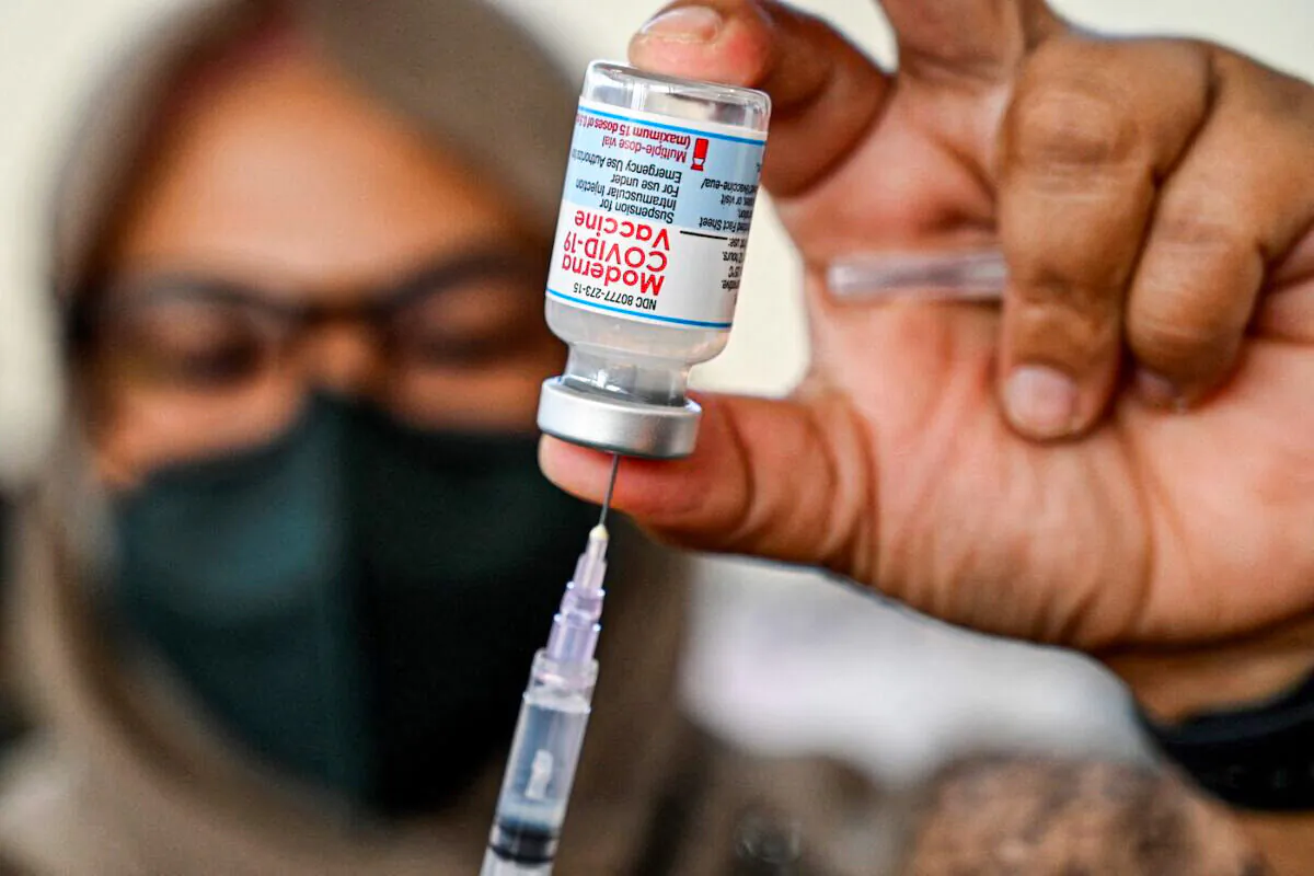 A health worker prepares a dose of the Moderna Covid-19 vaccine at a convention hall in Banda Aceh on Aug. 30, 2021. (Chaideer Mahyuddin/AFP via Getty Images)