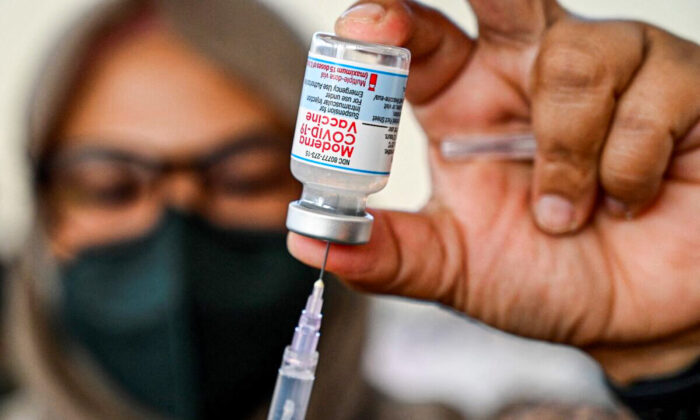 A health worker prepares a dose of the Moderna Covid-19 vaccine at a convention hall in Banda Aceh on Aug. 30, 2021. (Chaideer Mahyuddin/AFP via Getty Images)