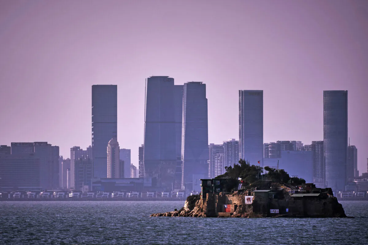 An Island that lies inside Taiwan's territory is seen with the Chinese city of Xiamen in the background on Feb. 04, 2021 off the coast of Lieyu, an outlying island of Kinmen that is the closest point between Taiwan and China. Kinmen, an island in the Taiwan strait that is part of Taiwan's territory, is so close to China that the deep-water port of Xiamen, one of China's biggest, lies less than three miles away across the water. It is one of the few areas of Taiwan that mainland Chinese tourists can visit without visas or permits.(An Rong Xu/Getty Images)