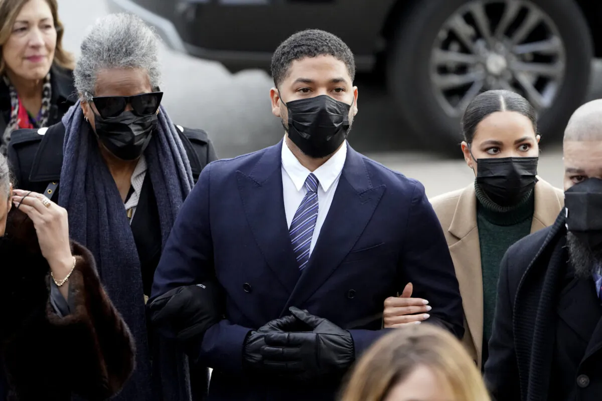 Actor Jussie Smollett walks with family members as they arrive at the Leighton Criminal Courthouse  
for jury selection at his trial in Chicago on Nov. 29, 2021. (Charles Rex Arbogast/AP Photo)