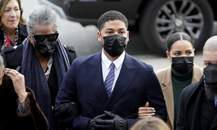 Actor Jussie Smollett walks with family members as they arrive at the Leighton Criminal Courthouse  
for jury selection at his trial in Chicago on Nov. 29, 2021. (Charles Rex Arbogast/AP Photo)