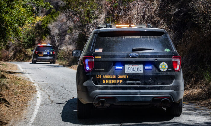 Los Angeles County Sheriffs Department with the Homeless Outreach Services Team patrol Malibu Canyon to assist homeless individuals on Sept. 24, 2021. (John Fredricks/The Epoch Times)