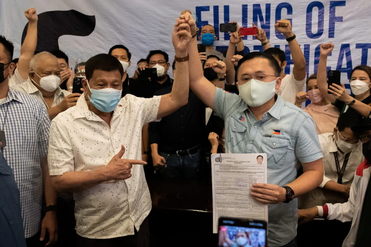Philippine President Rodrigo Duterte with Sen. Christopher "Bong" Go at the Commission on Elections, in Manila, Philippines, on Nov. 13, 2021. (Lisa Marie David/Reuters)
