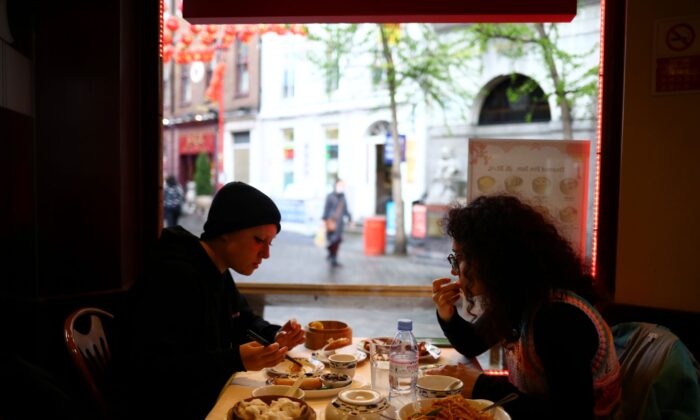 People sit inside a restaurant, amid the outbreak of the coronavirus disease (COVID-19), in Chinatown, London, Britain, on May 18, 2021. (Hannah McKay/Reuters)