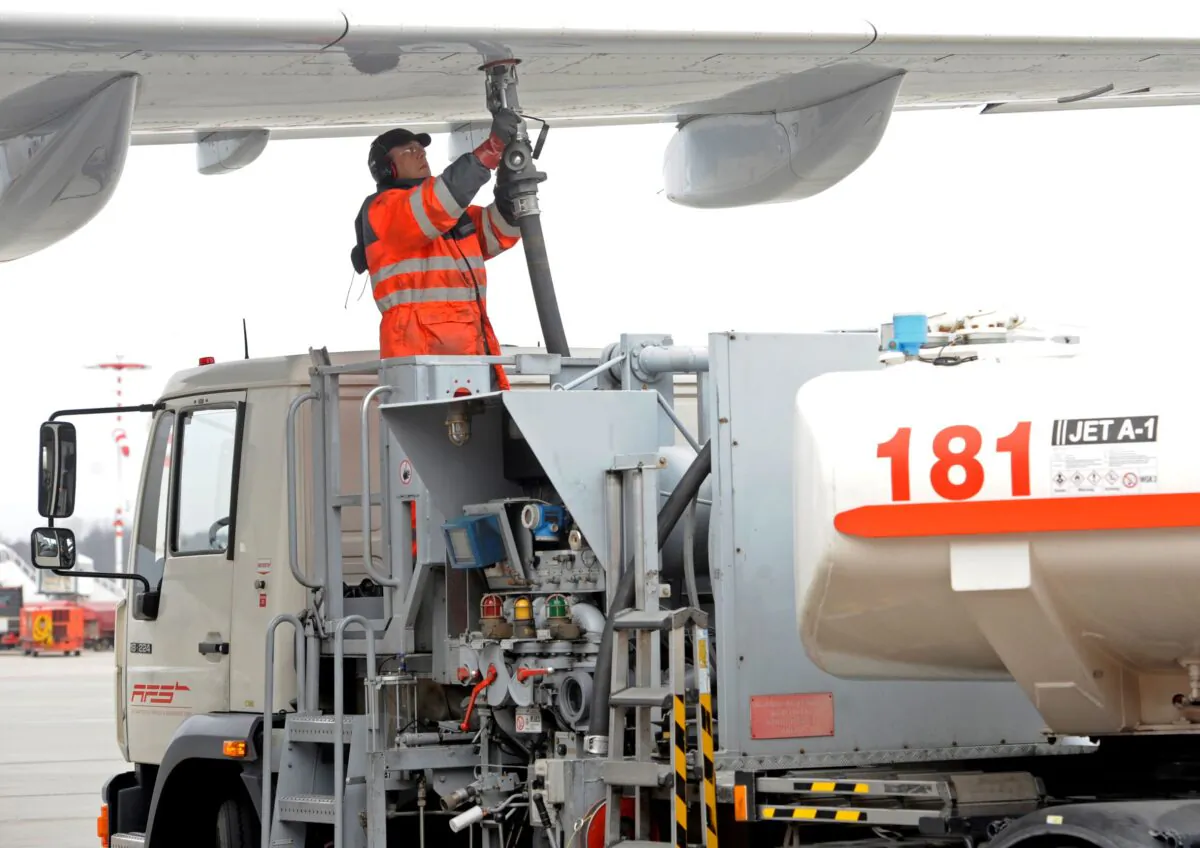 A worker fills an Airbus jet with aviation fuel at Fuhlsbuettel airport in Hamburg, on March 14, 2012. (Fabian Bimmer/Reuters)