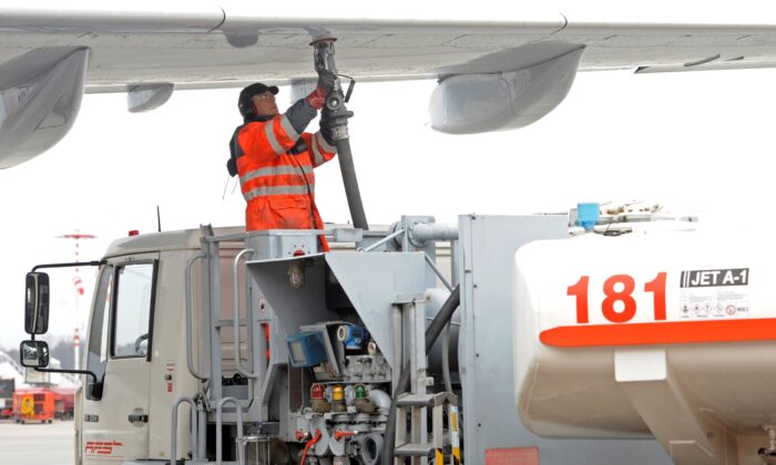 A worker fills an Airbus jet with aviation fuel at Fuhlsbuettel airport in Hamburg, on March 14, 2012. (Fabian Bimmer/Reuters)